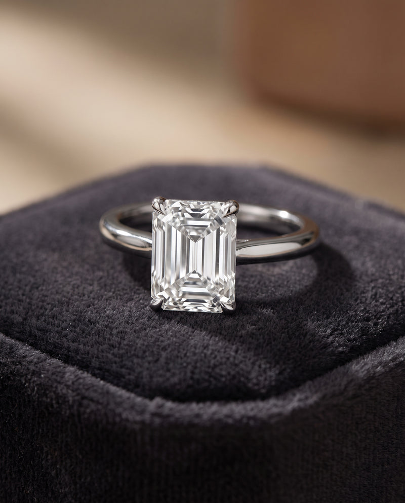 Emerald-cut diamond engagement ring on a velvet display, bespoke jewellery made in Hatton Garden