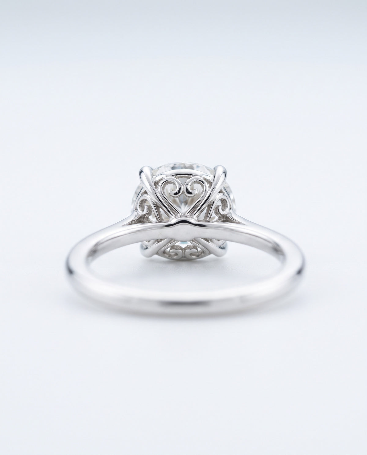 Back view of a diamond engagement ring showing the claws and gallery