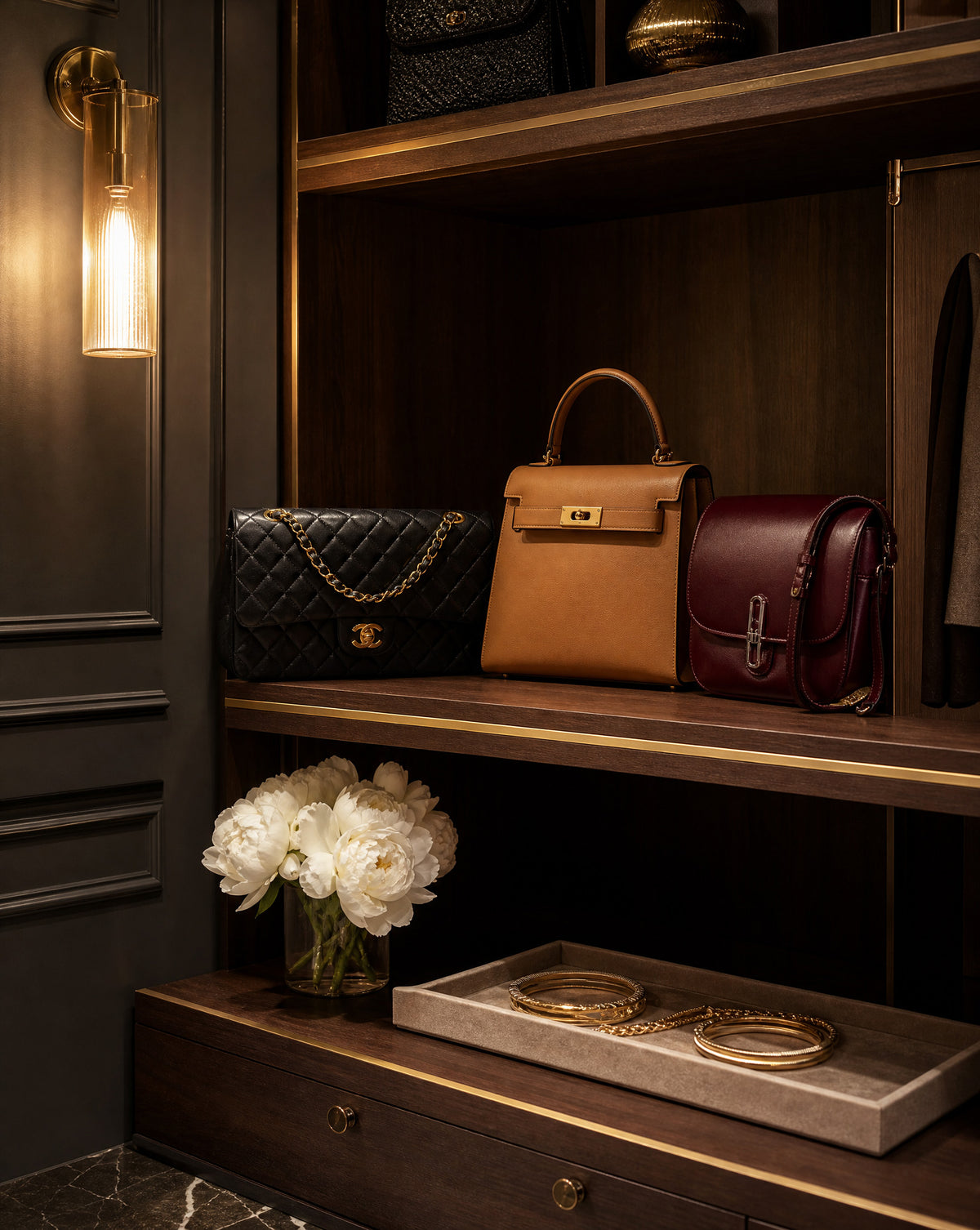 Chanel, Hermès and luxury handbags displayed on shelves, designer handbag valuation for insurance