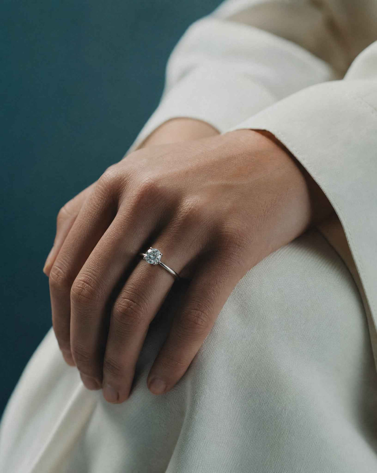 Woman wearing a diamond engagement ring, online jewellery valuation for insurance