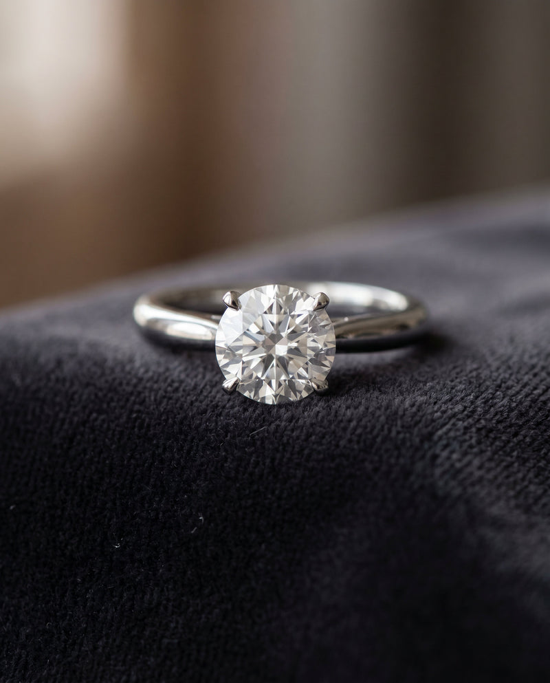 Round diamond solitaire ring in white gold on black velvet, online jewellery valuation