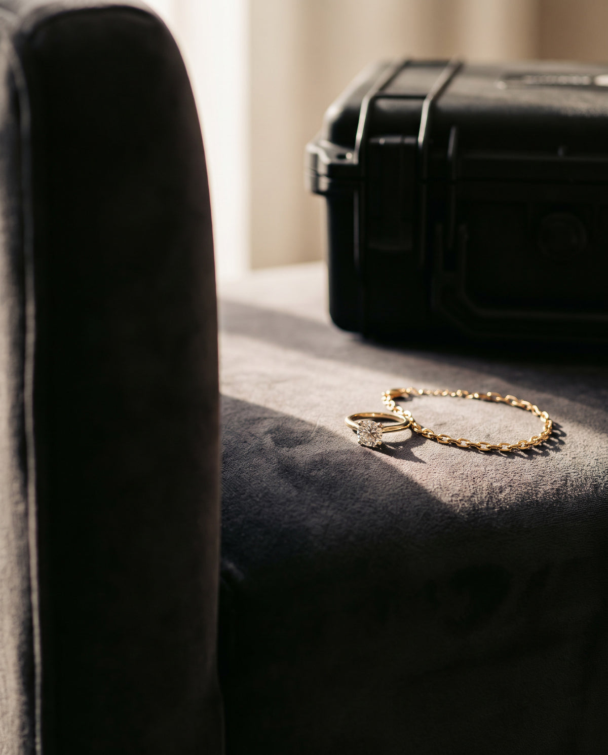 Gold bracelet and ring beside a secure case, insured postal valuation service