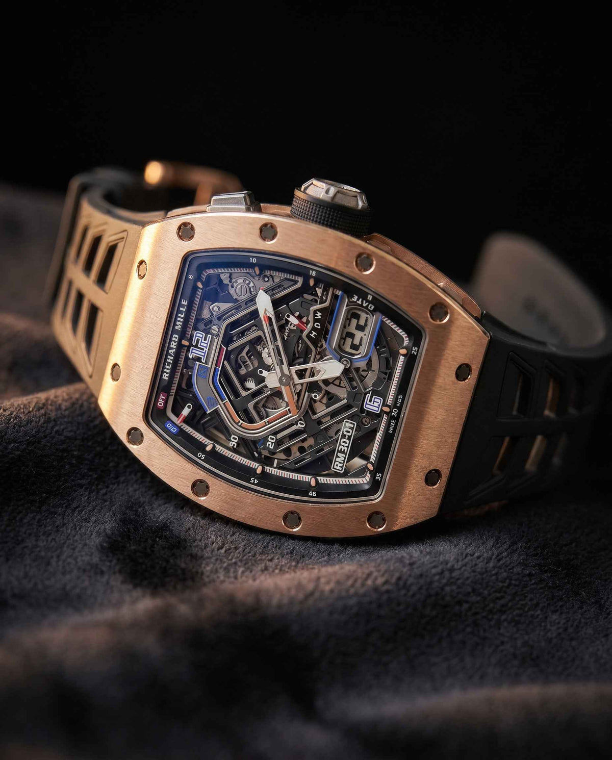 Rose gold Richard Mille skeleton watch on dark fabric, luxury watch valuation